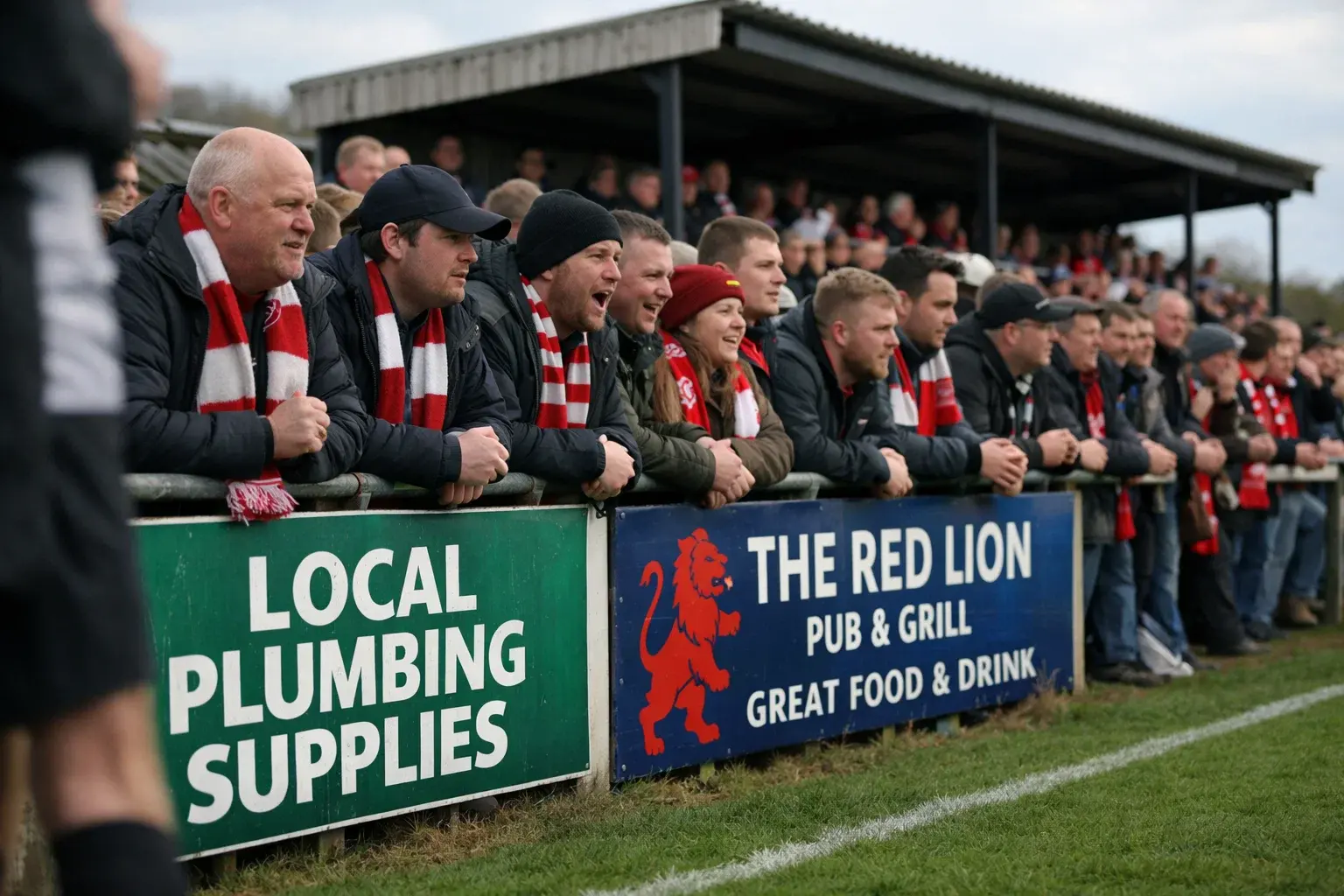 Fans at a lower league football ground with intimate atmosphere